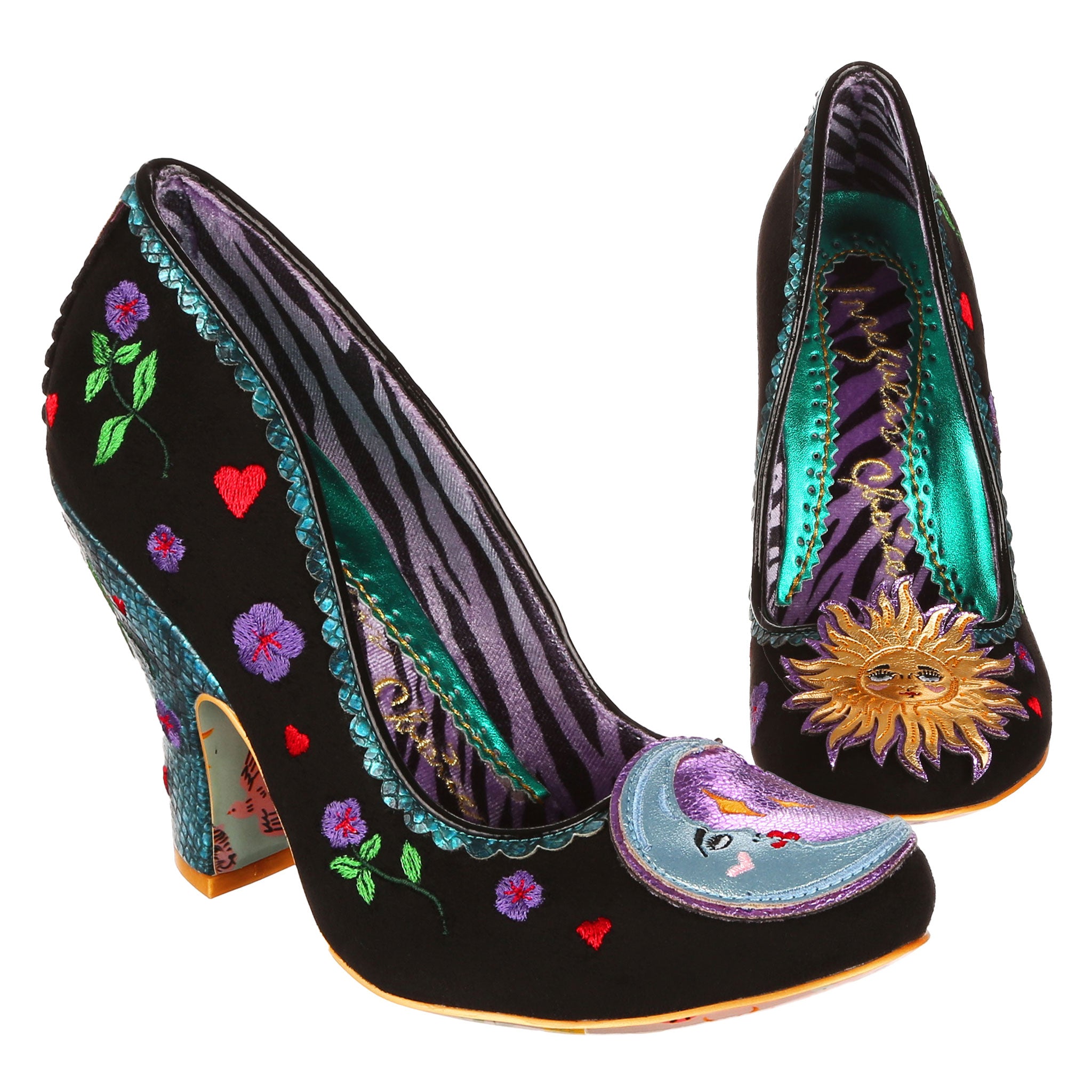 Black slip on high heels with blue snakeskin trim and heels, embroidered details up the side and a sun and moon applique on the toe on a white background.