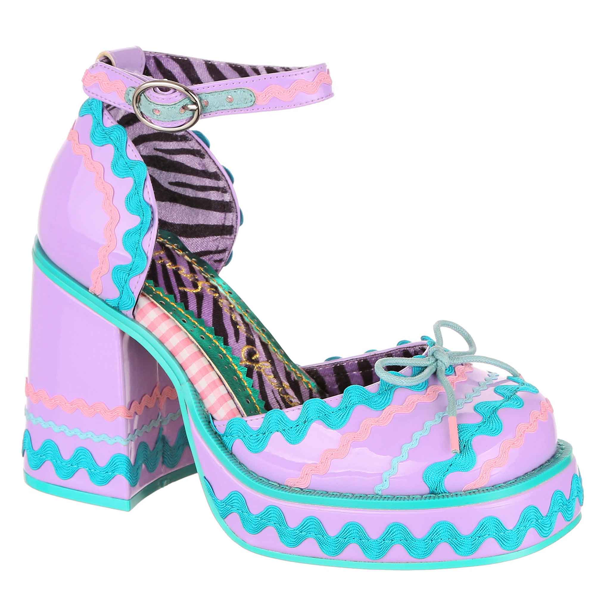 Lilac platform high heeled shoe with ankle strap and zigzag pattern on a white background