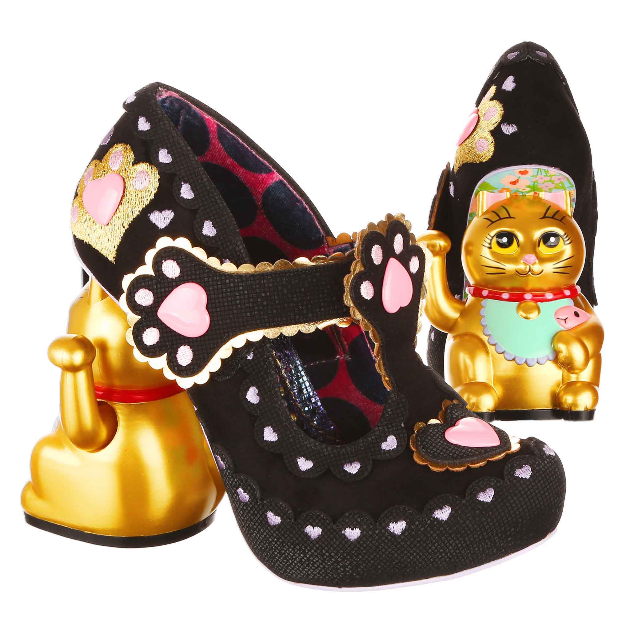 Black high-heeled t-bar shoes with embroidered pink heart details with gold waving cat concept heels on a white background