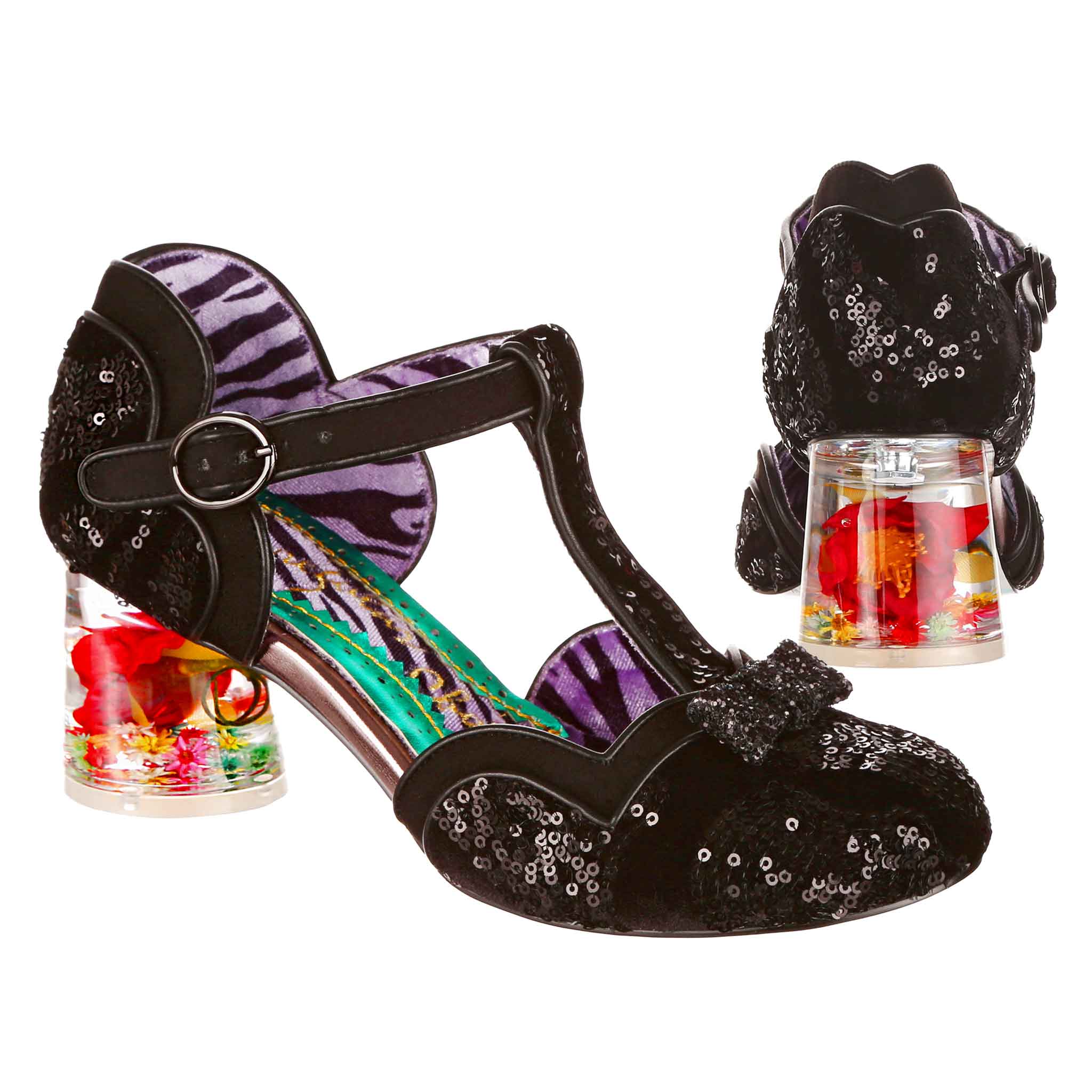 Black sequin t-bar shoes with a clear resin stacked low heel with flower set in it, a glitter bow on the toe and silver colour buckle fastening.