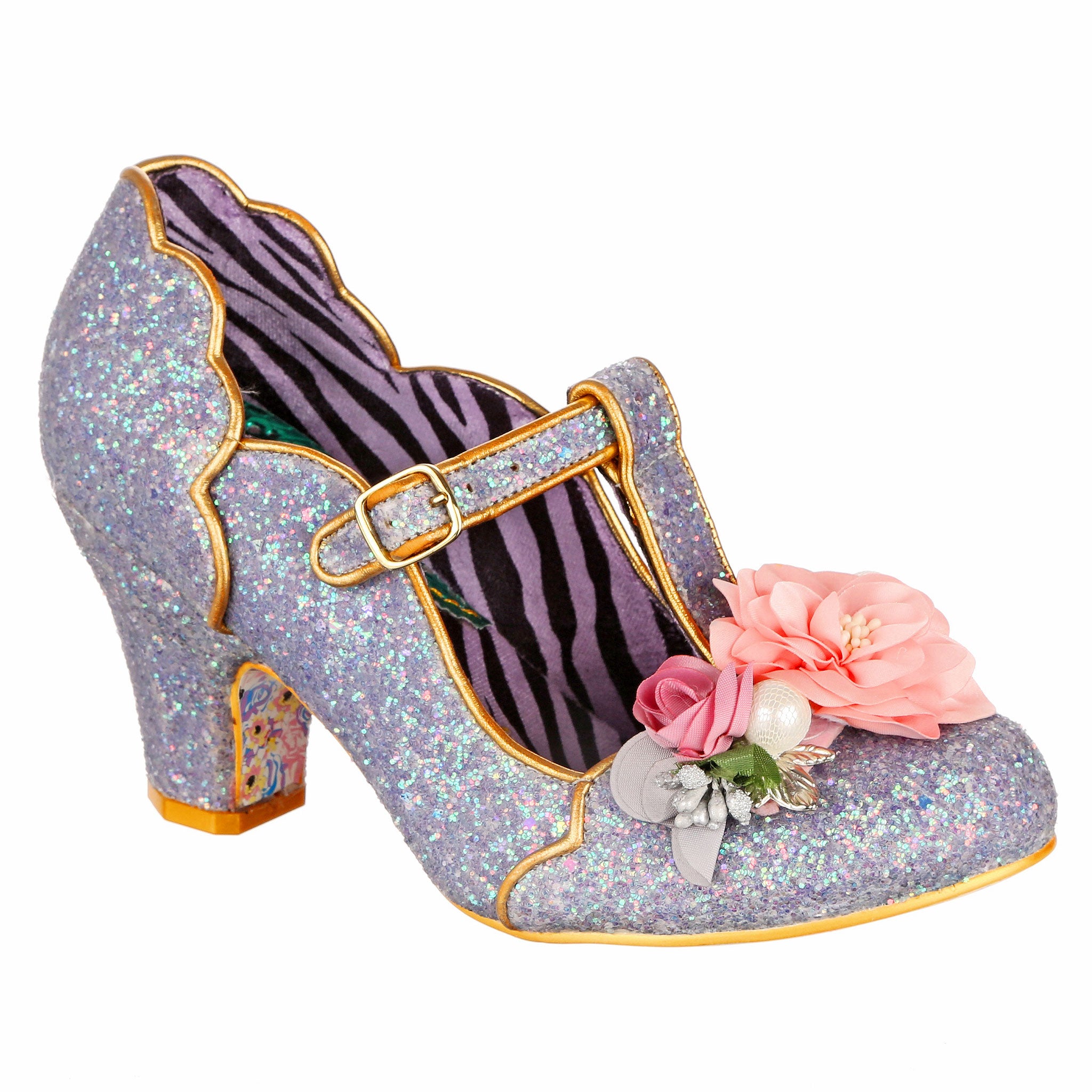 Sparkly glitter mid-heeled t-bar shoe with floral decorations on the toe and gold scalloped piping on a white background