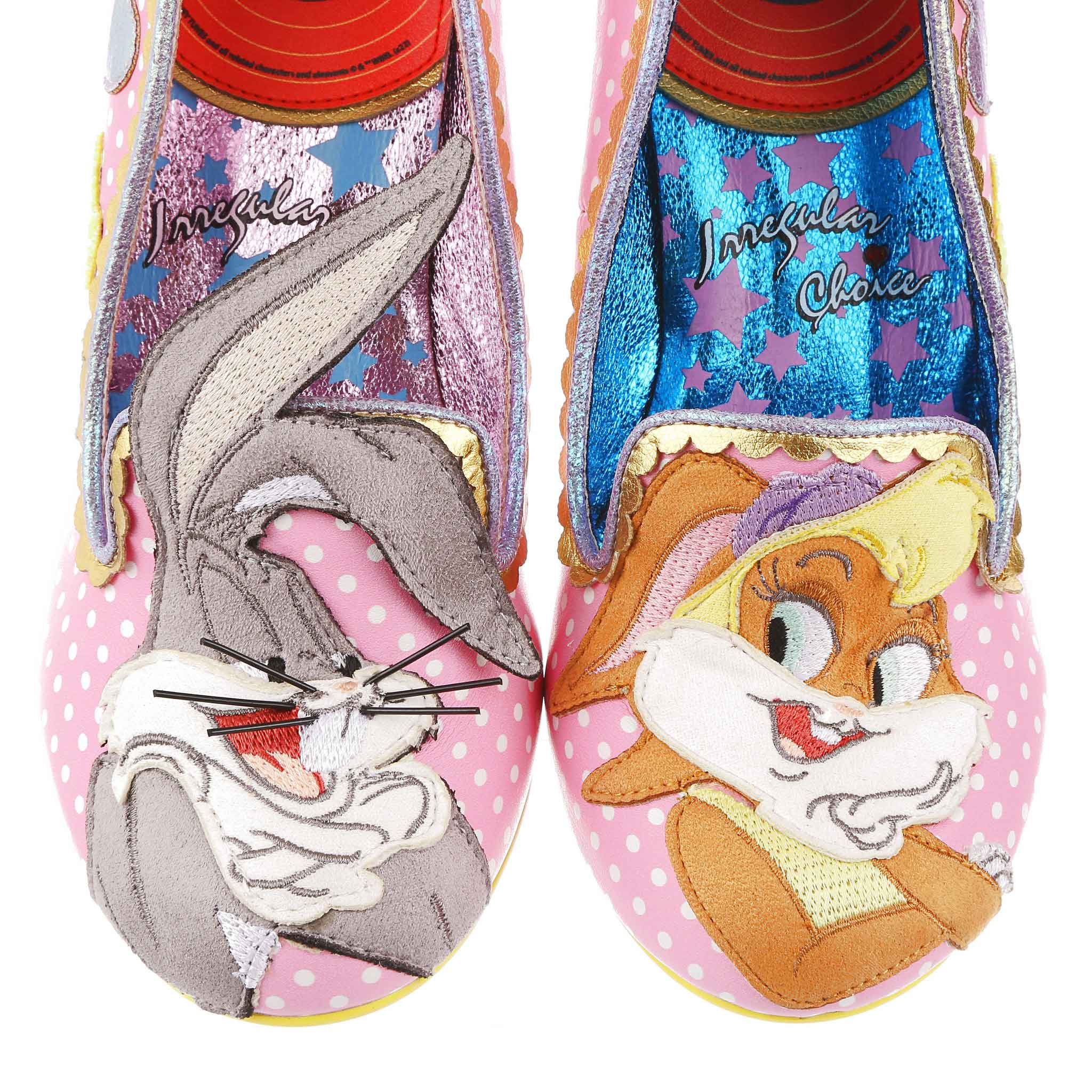 A pink and white polka dot with pastel glitter hearts, gold scalloping and Bugs Bunny appliqued on the right toe and Lola Bunny on the left toe. 