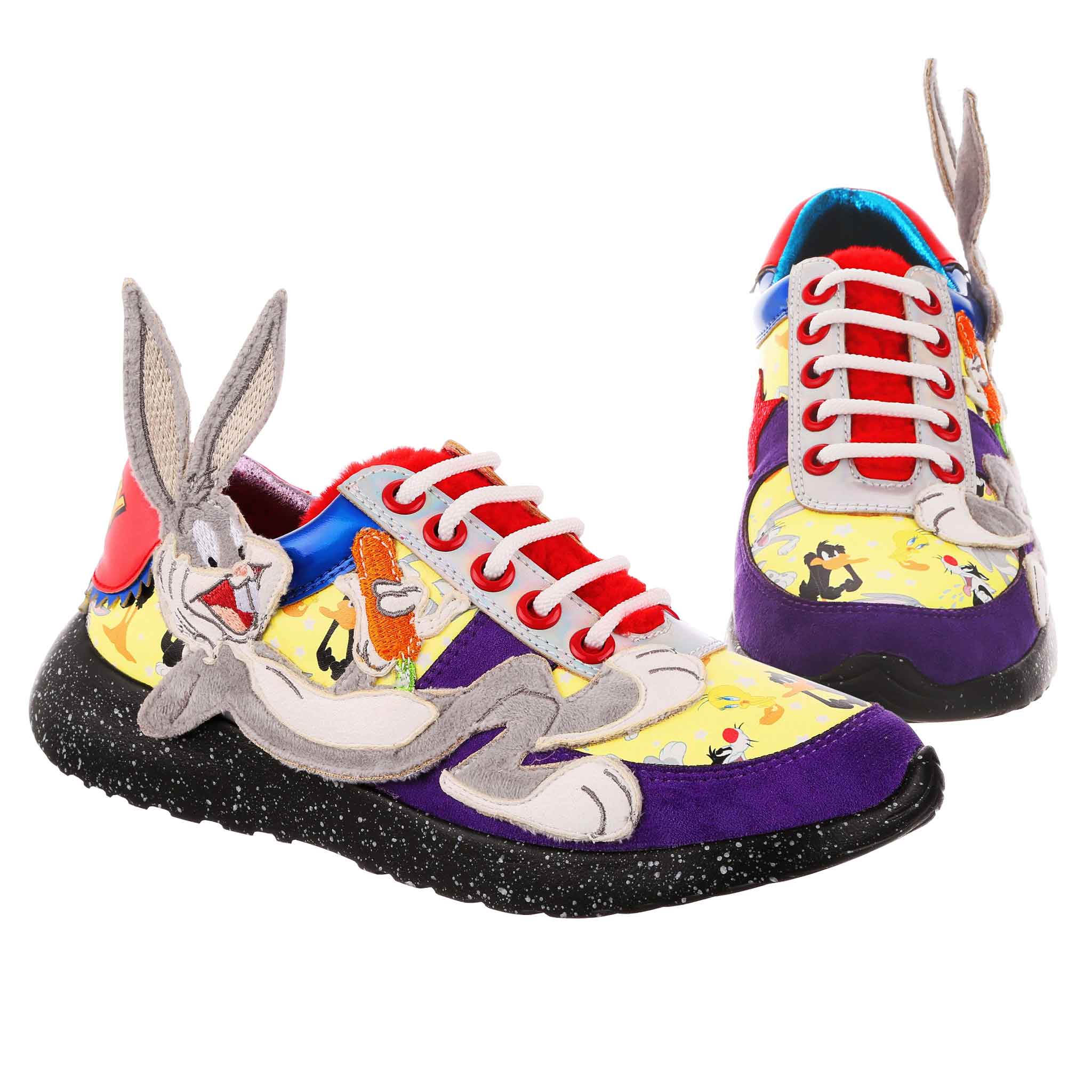 Lace-up trainers with purple suedette fabric, contrasted with yellow repeat pattern of popular Looney Tunes characters. A furry applique of Bugs Bunny lounging along the outside of the shoe, with his face and ears coming off of the shoe. A fluffy red tongue is matched to the logo printed on the heel.