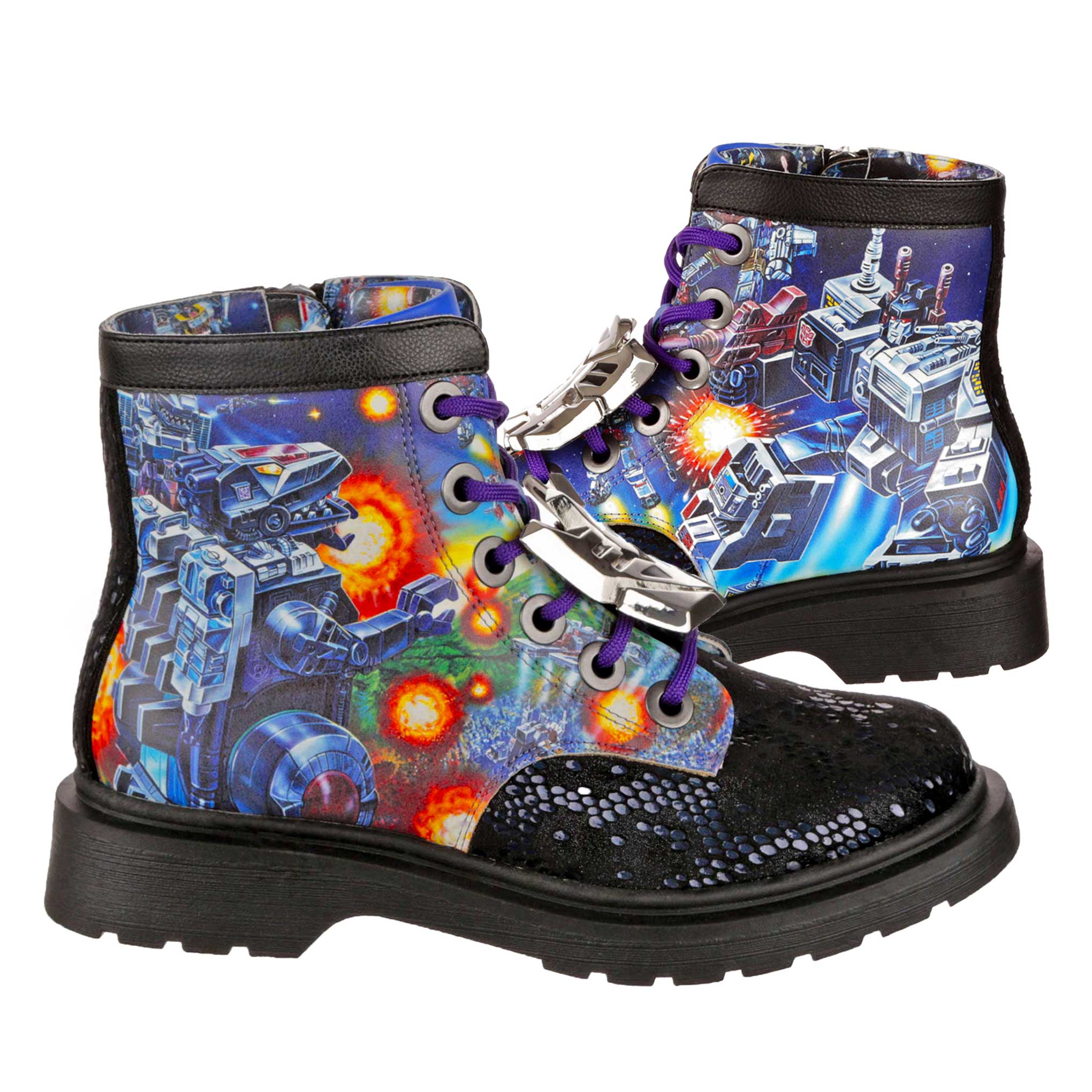 A pair of lace-up ankle boots with a vintage Transformers scene showing Trypticon battling Metroplex on either side of the boot. A black and metallic blue snakeskin print on the toe contrasts with the blue, orange and green Transformers print on the main body of the shoe. Black chunky soles match the black leather look piping on the boot. Purple laces thread through silver eyelets with silver metallic lace charms sitting on the laces. 