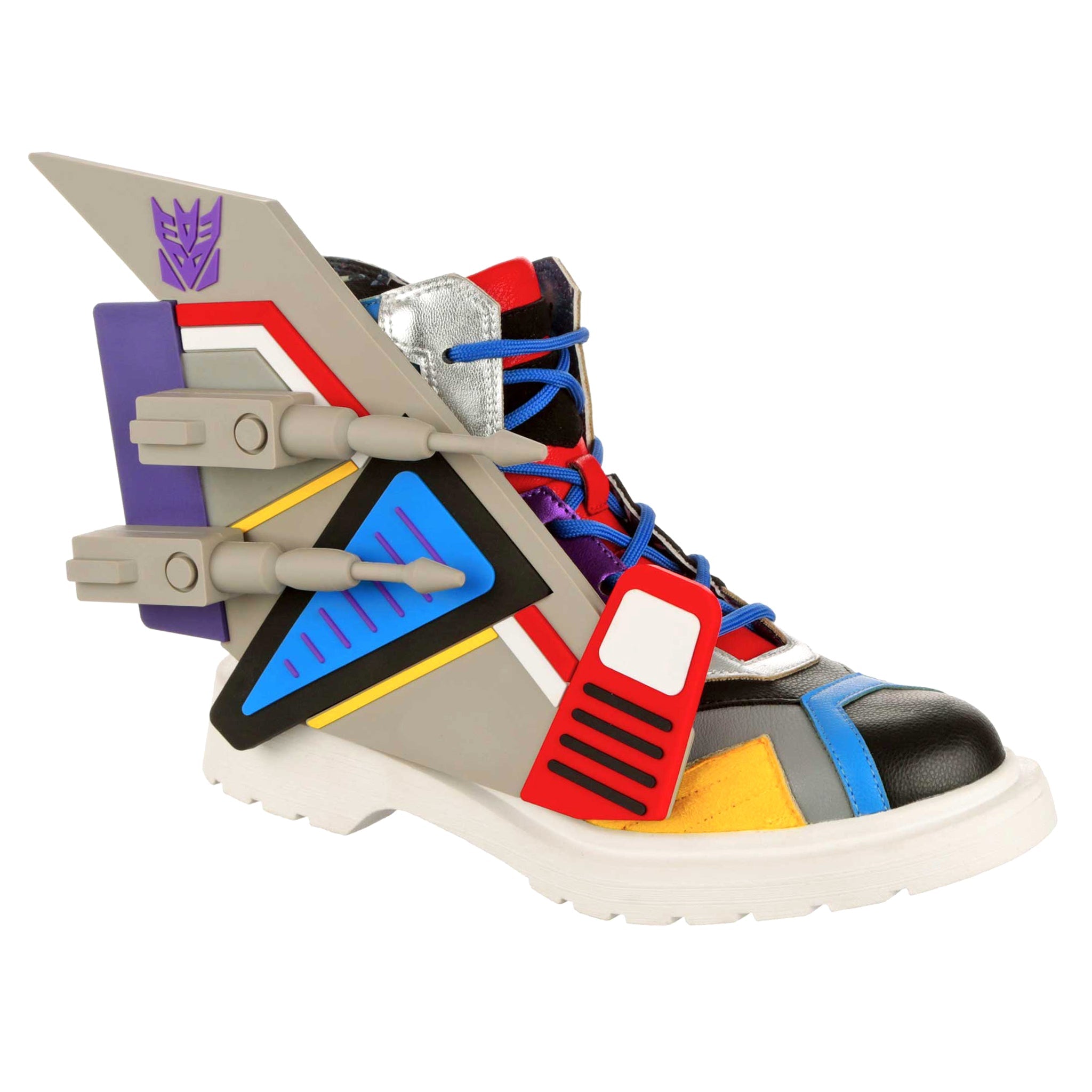 Transformers-themed grey ankle boots with blue laces, a black toe and chunky grey details. Removable grey jet wings sit on the side of the lace-up boots. A purple Decepticon logo sit on the side of the grey boots, finished off with a white chunky sole.