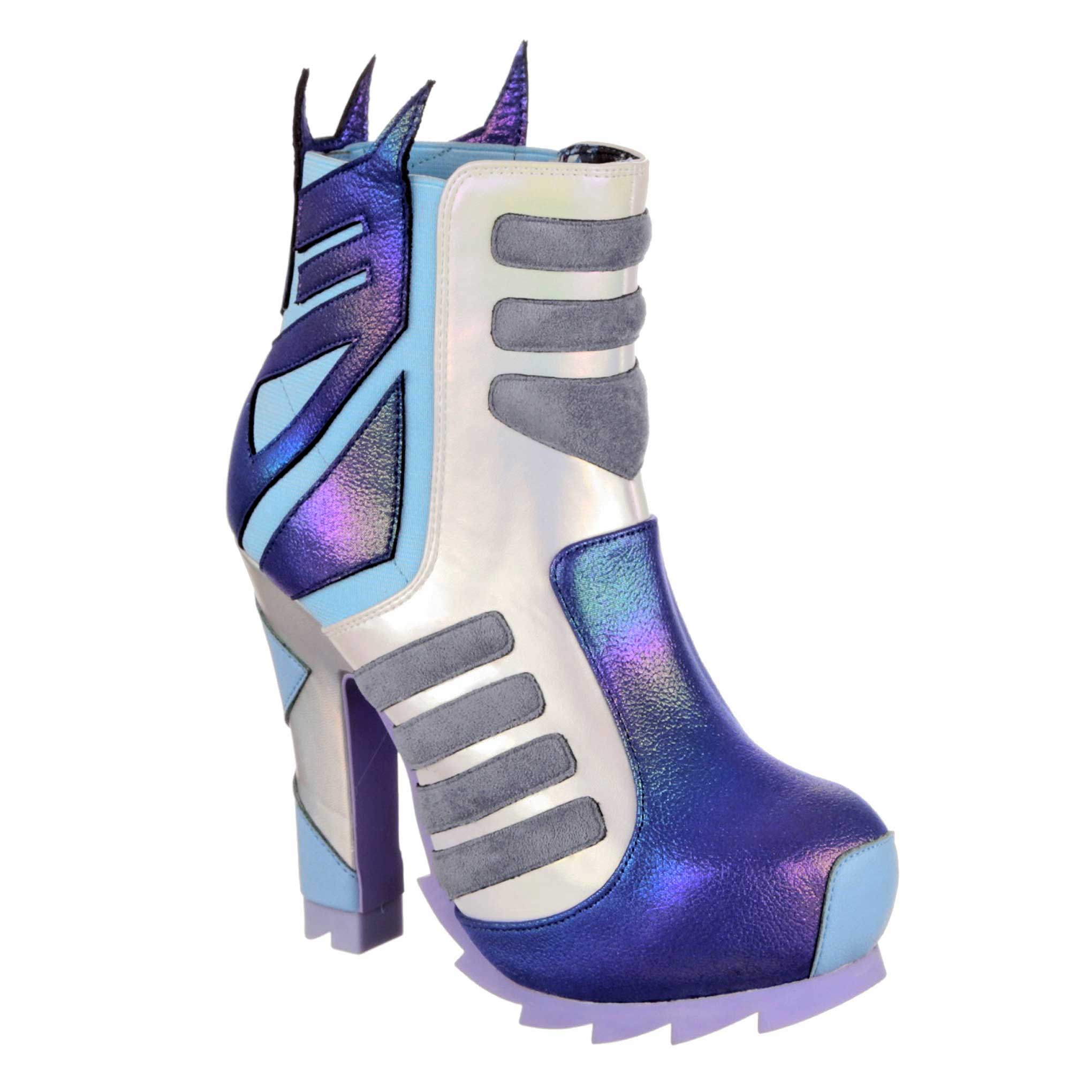 A multicoloured high-heeled ankle boot with large geometric shapes in purple, grey and light blue which is stitched onto the boot. A purple Decepticon logo on pale blue fabric wraps around the ankle whilst a chunky lilac platform soles finishes the boot. 